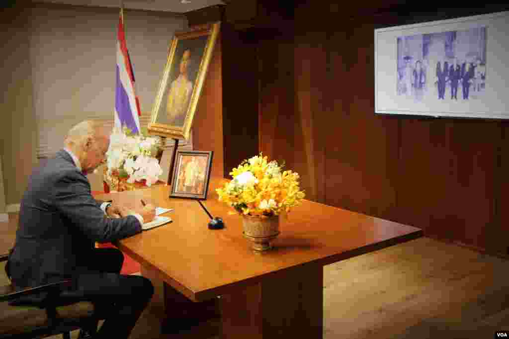 Vice President Joe Biden signs a book of condolences for His Majesty King Bhumibol Adulyadej