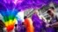 Kajsa Westman, second from right, of Stockholm, Sweden, and Victor Ng, right, of Seattle, tie balloons to a banner in preparation for the annual Gay Pride parade, file photo. 