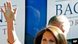 Republican presidential candidate Rep. Michele Bachmann, R-Minn., waves to supporters outside her campaign bus after being named the winner of the Iowa Republican Party's Straw Poll, Saturday, Aug. 13, 2011, in Ames, Iowa. (AP Photo/Charlie Neibergall)