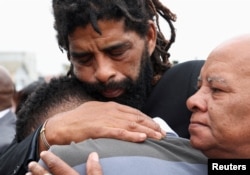 FILE—Theodore Fleurs, father of Luke Fleurs, grieves with family and friends at the football player's funeral outside the New Apostolic Church in Mitchell’s Plain, in Cape Town, South Africa, April 20, 2024.