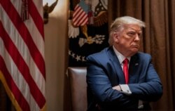 FILE - President Donald Trump listens during a White House meeting in Washington, July 9, 2020.