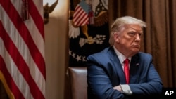 FILE - President Donald Trump listens during a White House meeting in Washington, July 9, 2020. 