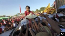 Supporters of India&#39;s main opposition wave at their candidate, Narendra Modi, as he arrives to file his election nomination papers in Varanasi.