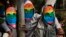 Kenyan gays, lesbians and others supporting their cause, wear masks to preserve their anonymity as they stage a protest against Uganda's increasingly tough stance against homosexuality, outside the Uganda High Commission in Nairobi, Kenya, Feb. 10, 2014. 