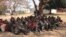 Illegal Ethiopian immigrants await trial outside the Karonga Court, Malawi, Sept. 24, 2014. (Tiwonge Kumwenda/VOA)