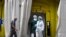FILE - Health care workers wearing protective gear wait outside a field hospital set up for coronavirus cases outside the CAP Prat de la Riba primary care center in Lleida, July 13, 2020.