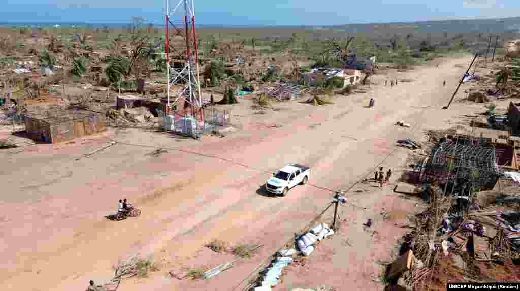 Pessoas caminham ao lado de edifícios destruídos&nbsp; depois de o ciclone Chido ter atingido o distrito de Mecufi, província de Cabo Delgado, Moçambique, a 16 de dezembro de 2024, nesta captura de ecrã retirada de um vídeo de um drone.&nbsp;