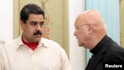 Venezuela's President Nicolas Maduro speaks with Claudio Maria Celli, the Vatican's representative, in Caracas, Venezuela 