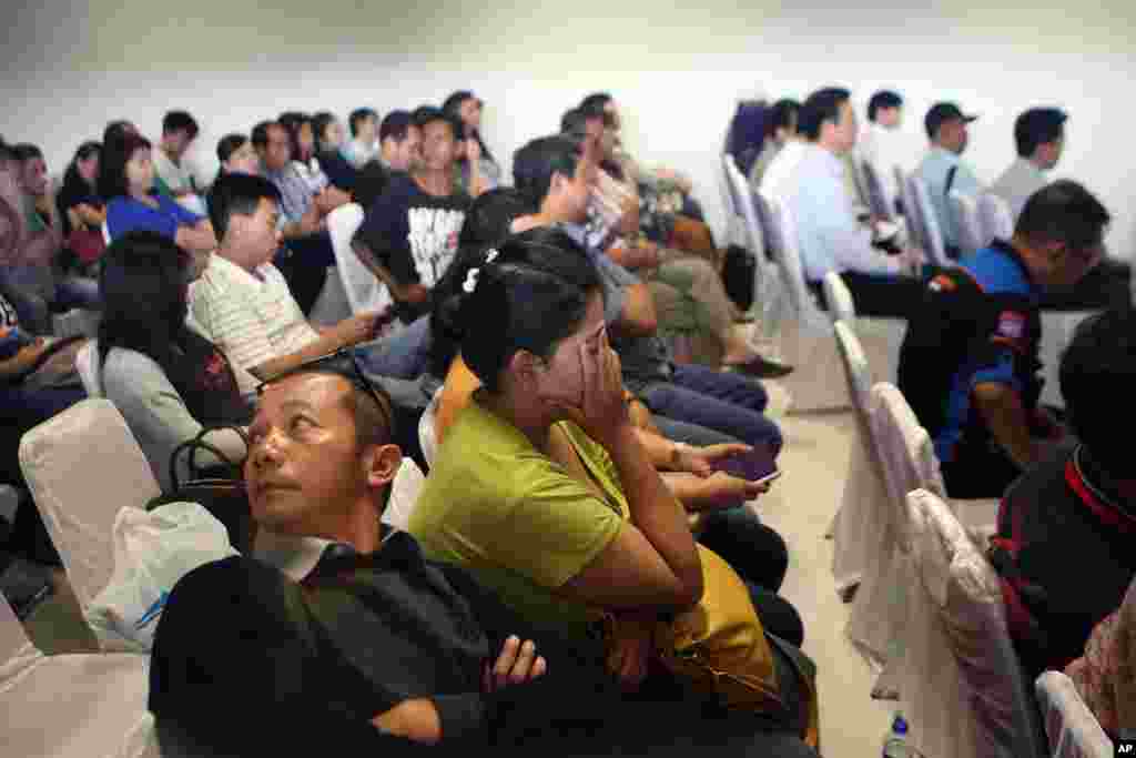 Relatives of passengers on the AirAsia flight 8501 wait for the latest news on the search for the missing jetliner at Juanda International Airport in Surabaya, East Java, Indonesia, Dec. 29, 2014.