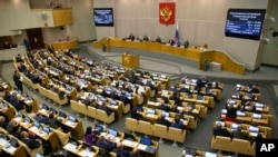 FILE - Lawmakers are seen in session in the State Duma, the lower house of the Russian Parliament in Moscow, Russia, Sept. 27, 2018. 