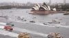 Competitors in the annual ferry boat race are supported by a spectator flotilla as they cruise past the Sydney Opera House as part of Australia Day celebrations in Sydney, Thursday, Jan. 26, 2017. 