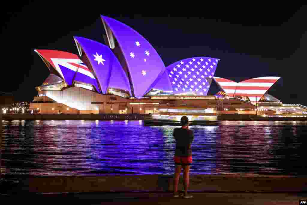The flags of the U.S. , Australia and New Zealand are projected onto the sails of the Opera House to commemorate the 70th anniversary of the alliance between the three countries, known as the ANZUS Treaty, in Sydney.