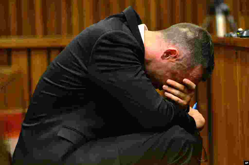 Oscar Pistorius cradles his head in his hands during court proceedings in Pretoria, May 5, 2014.