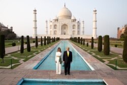 President Donald Trump, with first lady Melania Trump, pause as they tour the Taj Mahal, Feb. 24, 2020, in Agra, India.