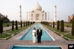 President Donald Trump, with first lady Melania Trump, pause as they tour the Taj Mahal, Feb. 24, 2020, in Agra, India.