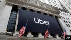 An Uber banner hangs on the facade of the New York Stock Exchange, May 10, 2019. 