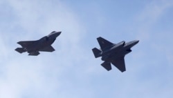 FILE - Two F-35 jets arrive at Hill Air Force Base in northern Utah, Sept. 2, 2015.