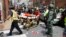 Rescue personnel help injured people after a car ran into a large group of protesters after an white nationalist rally in Charlottesville, Va., Aug. 12, 2017. 