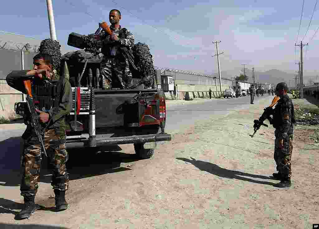 Afghan security forces members keep guard at the site of a car bomb attack in Kabul. (Reuters)