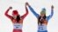 Women's downhill gold medal winners Switzerland's Dominique Gisin, left, and Slovenia's Tina Maze step onto the podium together at the Sochi 2014 Winter Olympics, Feb. 12, 2014, in Krasnaya Polyana, Russia.