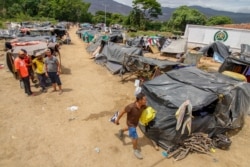Venezuelan migrants attempting to return to their country due to the COVID-19 pandemic remain in makeshift camps at the Simon Bolivar International Bridge in Cucuta, Colombia, July 7, 2020.