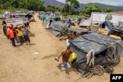 Venezuelan migrants attempting to return to their country due to the COVID-19 pandemic remain in makeshift camps at the Simon Bolivar International Bridge in Cucuta, Colombia, July 7, 2020.