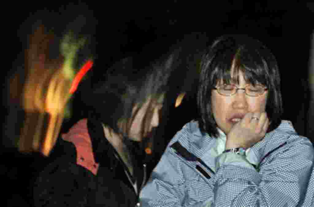 A Japanese woman reacts Friday, April 8, 2011 in Ishinomaki, Iwate Prefecture, northern Japan, after a 7.1-magnitude earthquake struck offshore, late Thursday. (AP Photo/Vincent Yu)