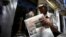 FILE - A vendor holds a copy of Cuba's state newspaper, Granma, in Havana, Aug. 13, 2015. 