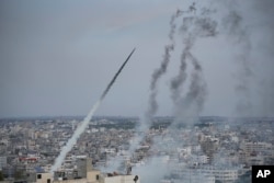 Rockets are launched by Palestinian militants from the Gaza Strip towards Israel, in Gaza, Oct. 7, 2023.