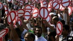 Hundreds of Bahrainis head to the streets for an unauthorized flash march to show their support for an opposition-called boycott of Saturday's parliamentary and municipal elections after midday prayers in Diraz, Bahrain, Friday, Nov. 21, 2014. 