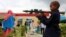 FILE - A Somali boy plays with a toy model of a rocket-propelled grenade (RPG) in Mogadishu, July 6, 2016. Children have been maimed and killed playing with real weapons, ordnance and explosive devices.