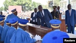 Felix Tshisekedi shakes hands with members of the Constitutional Court during his inauguration as the new president of the Democratic Republic of Congo, at the Palais de la Nation, in Kinshasa, Jan. 24, 2019. On Monday, a new parliament was sworn in.