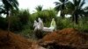 Workers bury the remains of Mussa Kathembo, an Islamic scholar who had prayed over those who were sick in Beni, Congo, July 14, 2019. Kathembo himself died of Ebola.