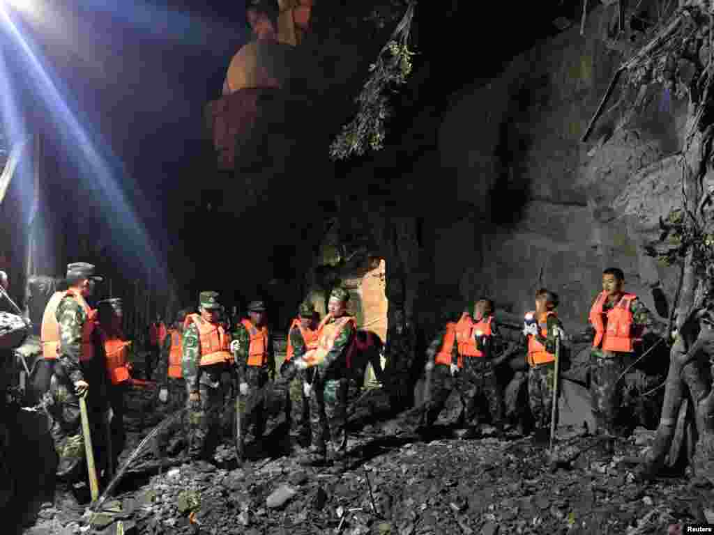 Chinese paramilitary police search for survivors after an earthquake in Jiuzhaigou county, Ngawa prefecture, Sichuan province.