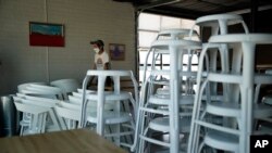 Workers make preparations for reopening at Vesta Coffee Roasters, May 8, 2020, in Las Vegas. Nevada.