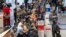Dozens of people line up to catch an Air France flight to Paris at Tambo International Airport in Johannesburg, South Africa, Nov. 26, 2021.