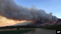 A wildfire burns off of the hills next to CA-126 highway, just northwest of Fillmore, California, Dec. 7, 2017. 