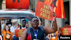 FILE - Activists participate in a demonstration against fossil fuels, during the United Nations Climate Change Conference COP28 in Dubai, United Arab Emirates, December 5, 2023.