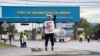 A dockworker demonstrates after a shipping port strike went into effect across the East Coast at the Port of Wilmington, Del., Oct. 1, 2024