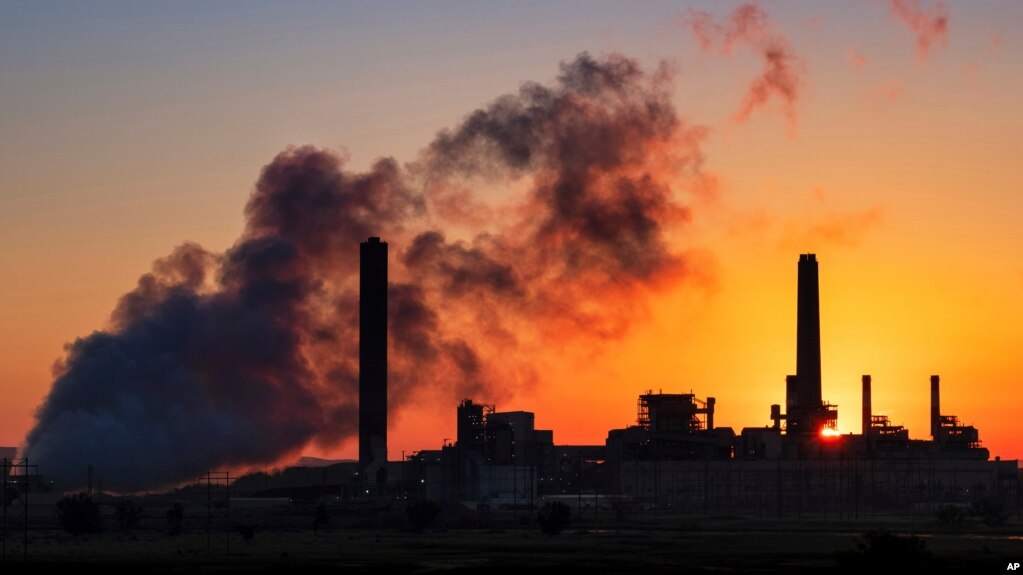 FILE - The Dave Johnson coal-fired power plant is silhouetted against the morning sun in Glenrock, Wyo., July 27, 2018.