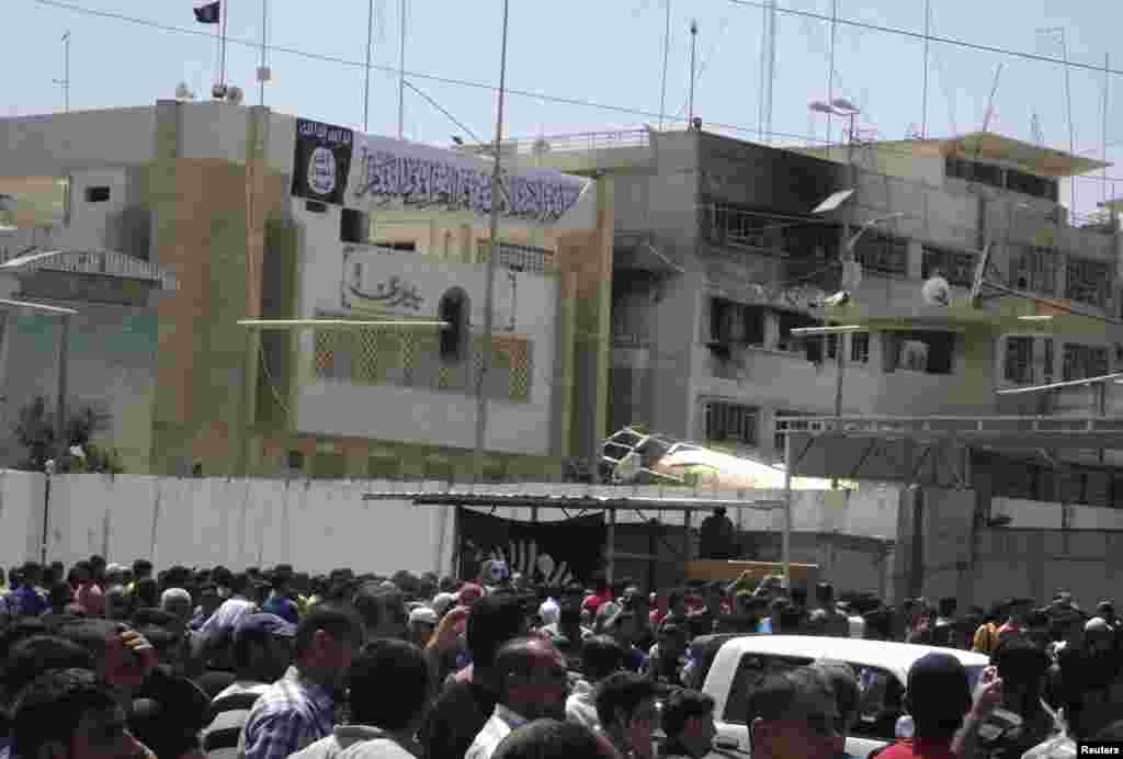 Residents gather at governorate building of Nineveh province after the Islamic State of Iraq and the Levant took control in the city of Mosul, Iraq, June 16, 2014.