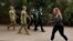 ADF personnel and Victorian police officers patrol a walking track as Melbourne remains in lockdown restrictions, In Melbourne, Australia, July 26, 2020. (AAP Image/Daniel Pockett via Reuters) 