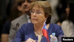 FILE - Chile's President Michelle Bachelet attends a session of the Summit of Heads of State of MERCOSUR and Associated States in Luque, Paraguay, Dec. 21, 2015.