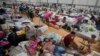 People who evacuated their flooded homes rest in a shelter amid heavy rain in Porto Alegre, Rio Grande do Sul state, Brazil, May 8, 2024.