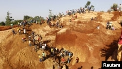 FILE - Gold prospectors work at an open pit in the village of Nyang'oma Kogelo, west of Kenya's capital Nairobi, July 15, 2015. 