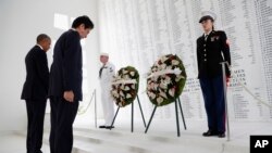 U.S. President Barack Obama and Japanese Prime Minister Shinzo Abe lay wreaths in a ceremony at the U.S.S. Arizona Memorial in Pearl Harbor.