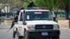 FILE - Armed police officers monitor the area after gang violence in the neighborhood on the evening of March 21, 2024, in Port-au-Prince, Haiti, March 22, 2024.