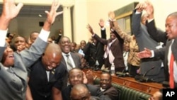 Zimbabwe’s Movement for Democratic Change members of parliament celebrate the victory of Lovemore Moyo, center, who won the election to determine the next speaker of the country’s Parliament, March, 29, 2011.