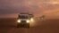 This photo released by the Syrian Arab Red Crescent, shows a convoy of vehicles of the Syrian Arab Red Crescent driving in the Syrian desert heading to Rukban camp between the Jordan and Syria borders, Nov. 4, 2018.