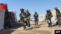 FILE: An image obtained from the media office of the Kurdish People's Protection Units in Syria (YPG) March 29, 2021 shows YPG forces conducting a security operation the previous day at the Kurdish-run al-Hol camp.